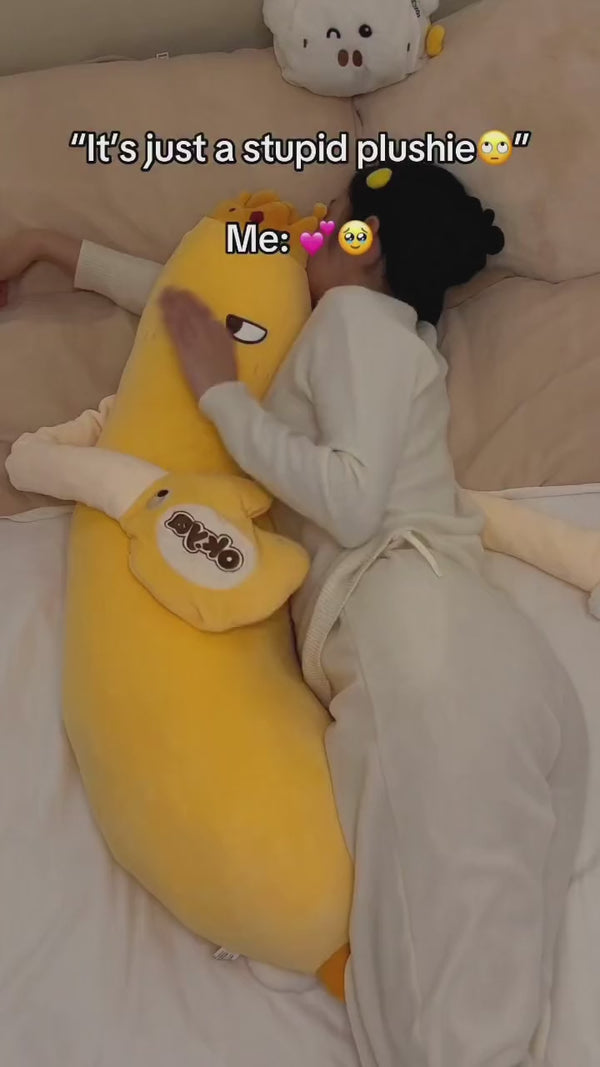 Cuddling a Pliumo plush in bed