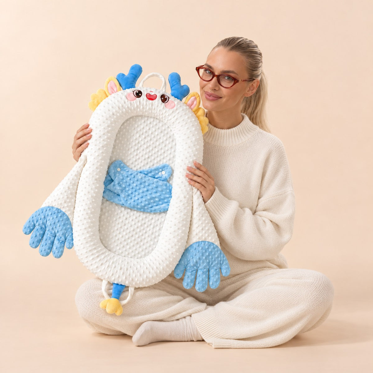 Woman holding the Pliumo Kids Cozy Baby Lounger