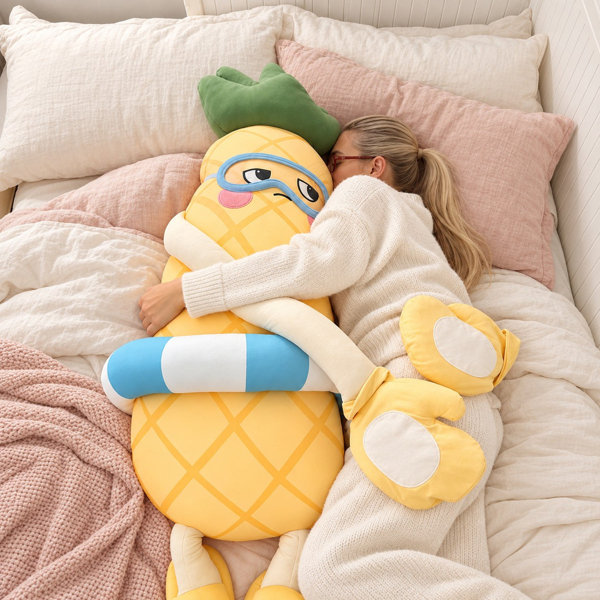 Woman hugging Pip the Pineapple in bed