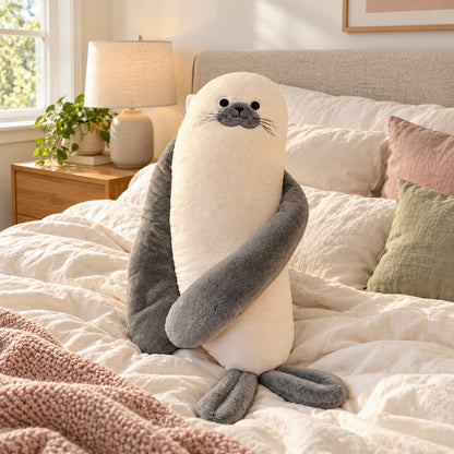 Sully the Seal plush pillow on a cozy bed